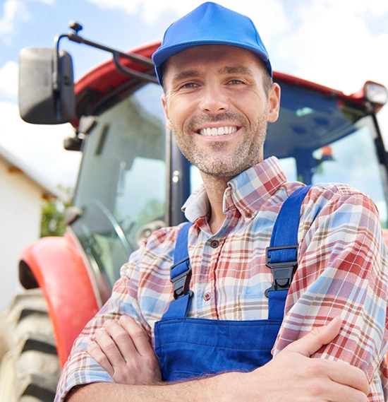 A successful farmer with tractor on his farm