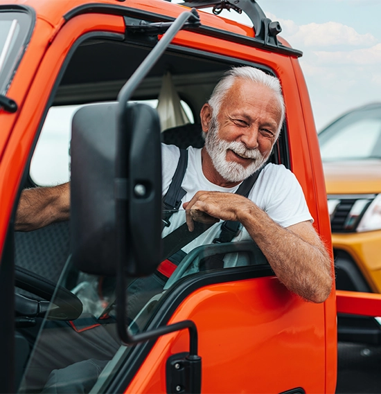 A senior man in a towing service on the road