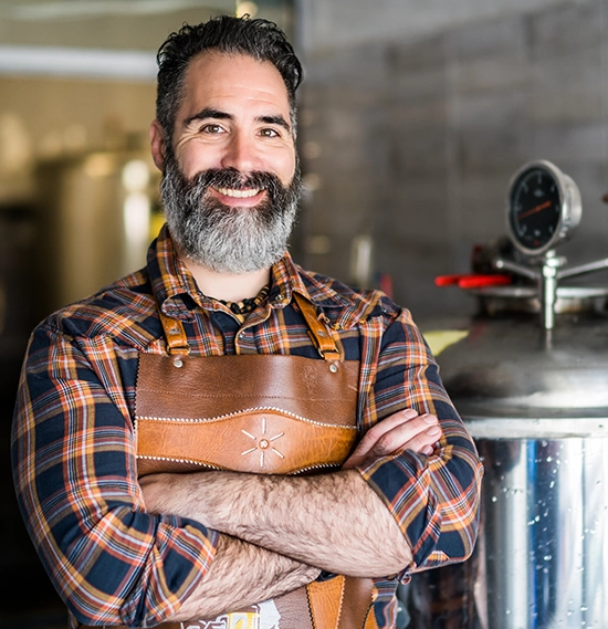 Man standing in front of craft beer machinery